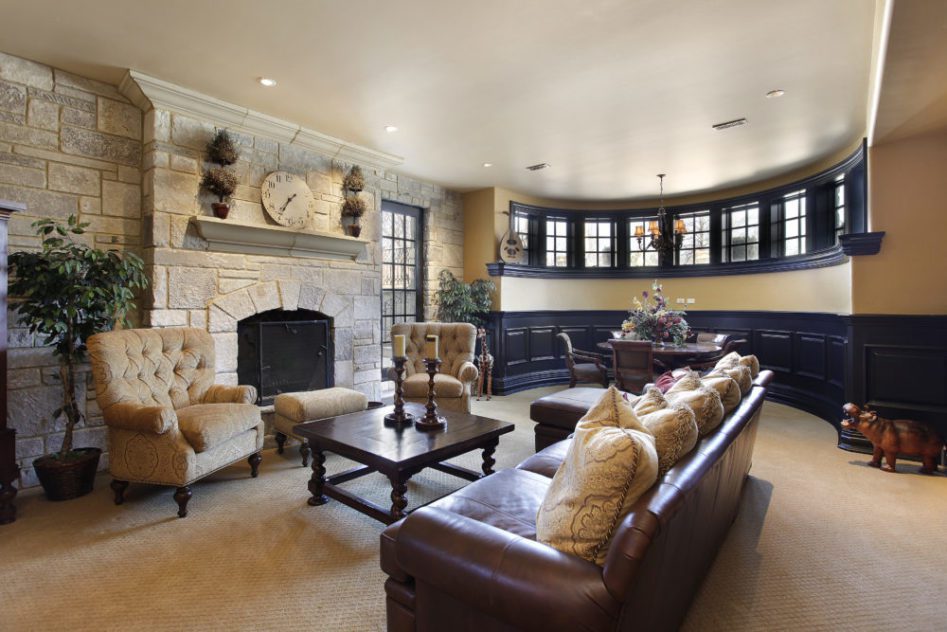 Beautiful finished basement in a luxury home with a stone fireplace