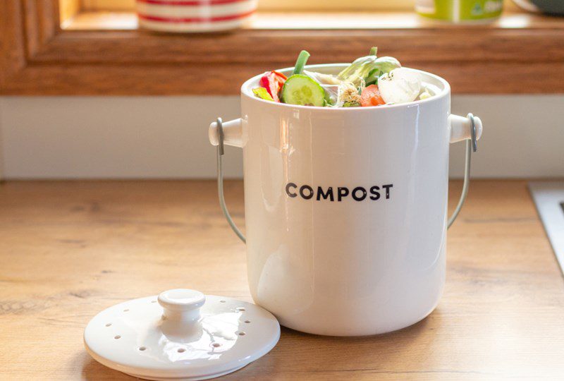 White ceramic pot with vegetable compost scraps