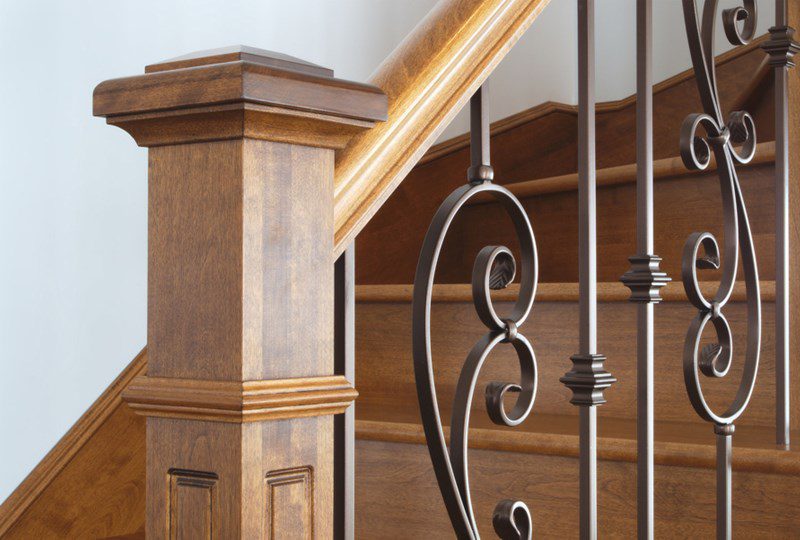 Photo of staircase bannister and black iron spindles.