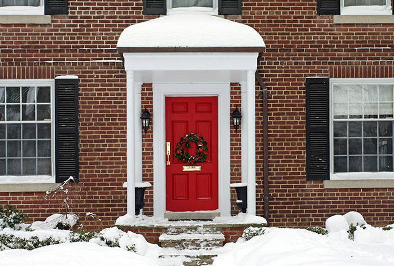 Beautiful brick home with white pillers and red door