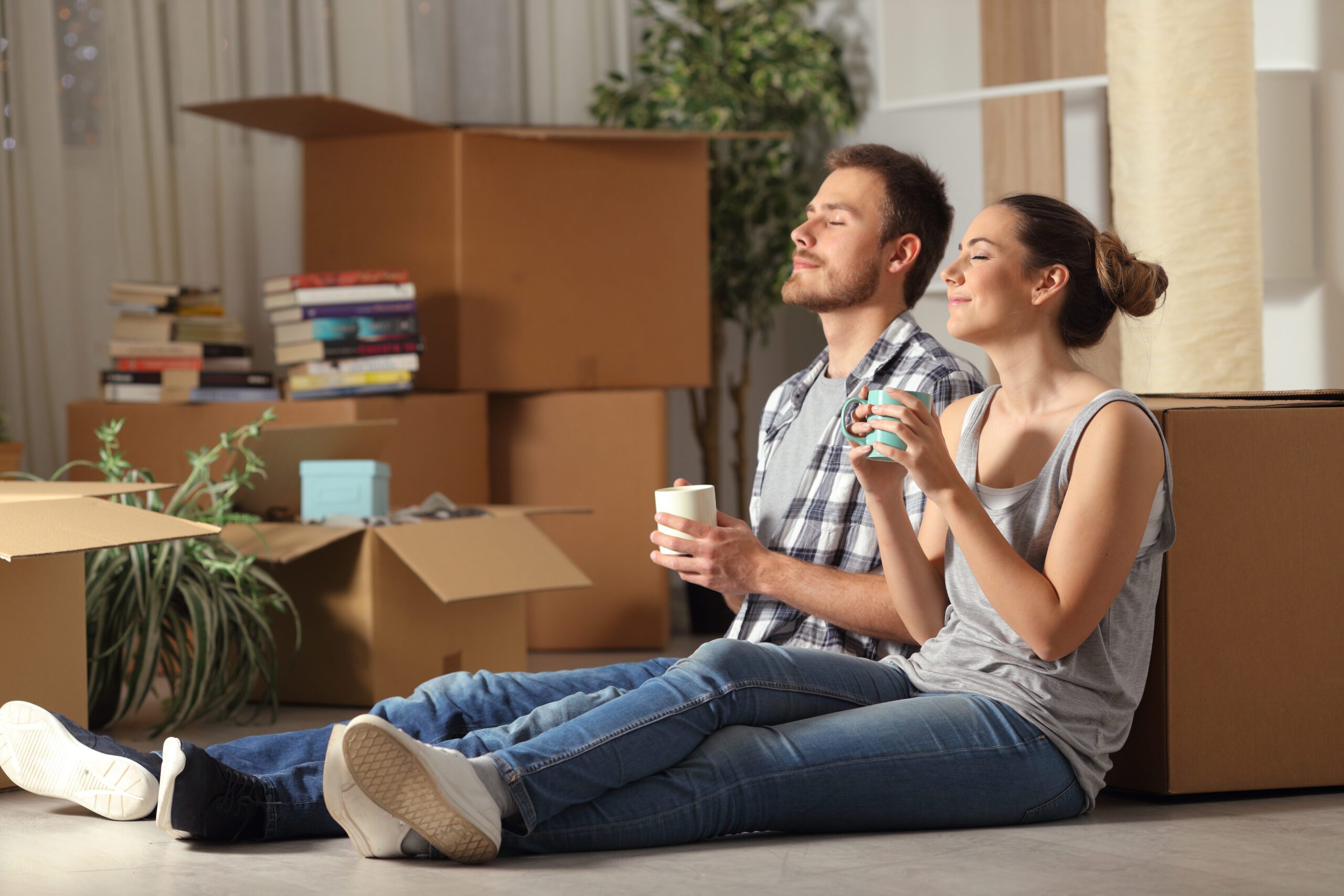 New homebuyers resting against moving boxes