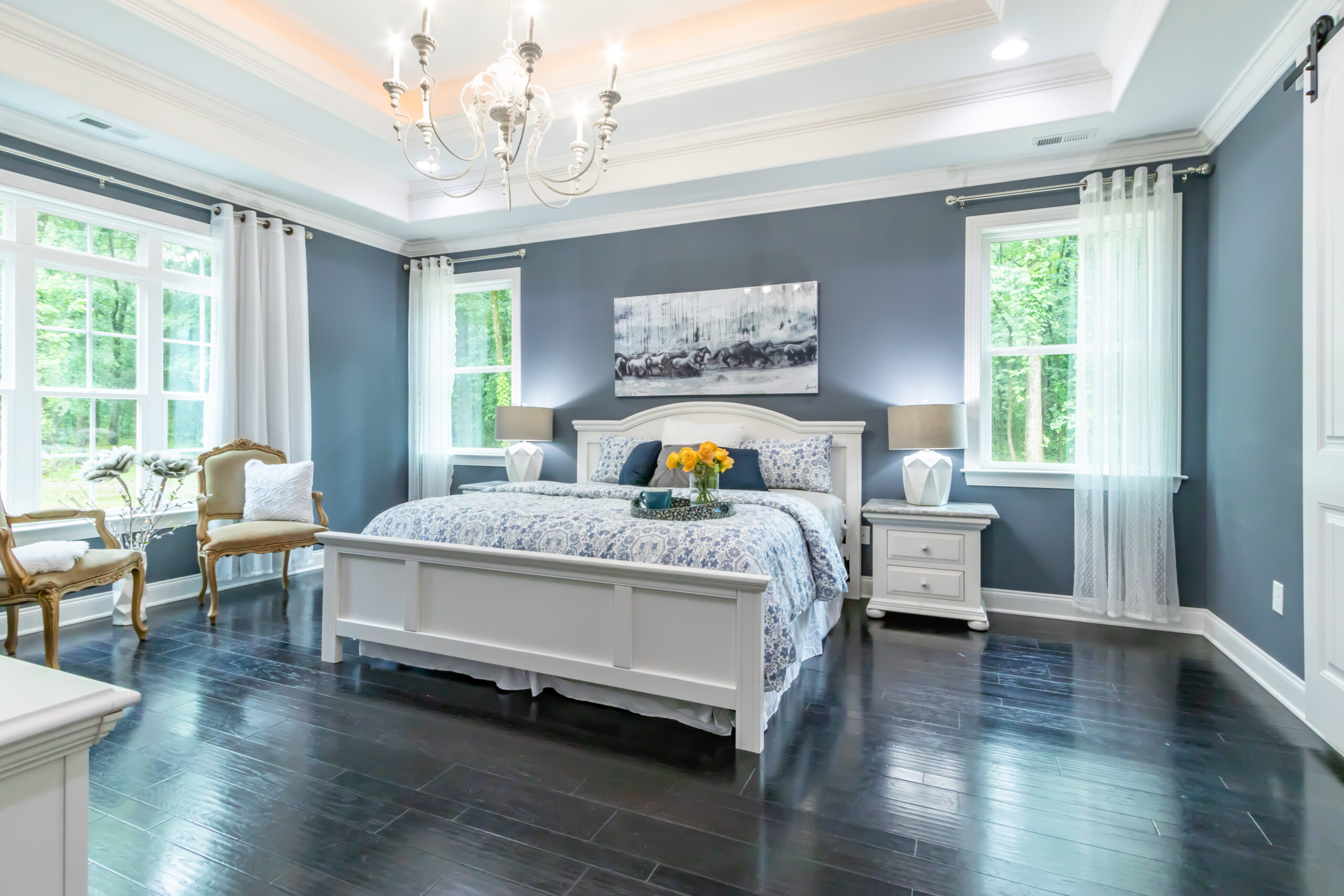 Beautiful interior design of bedroom with painted light grey walls - article decoding common paint terms.