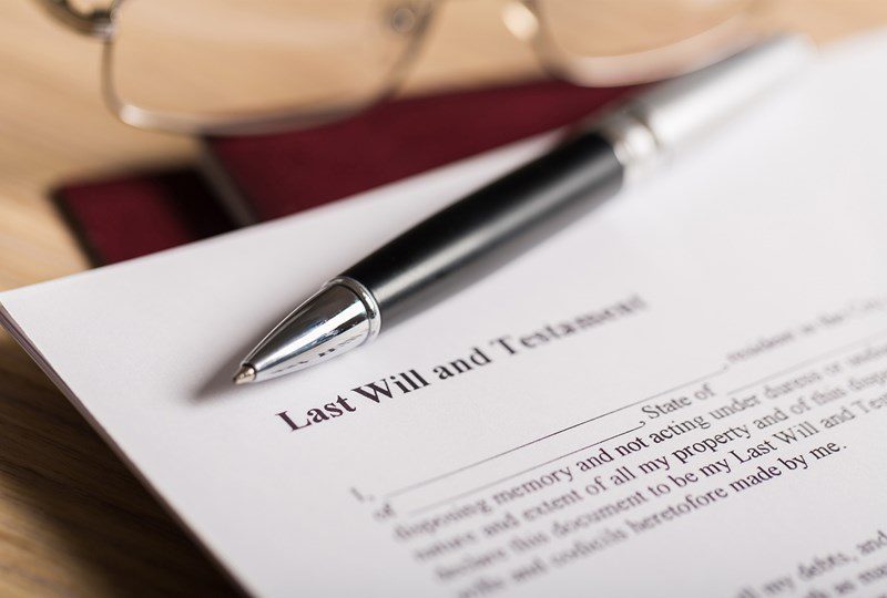 Silver and black pen on top of will, learn what to do if you inherit real estate property