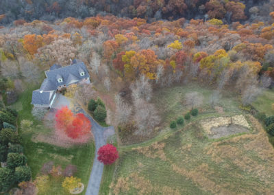 Overview of home with surrounding woods, aerial view. Photography by Steven Buri